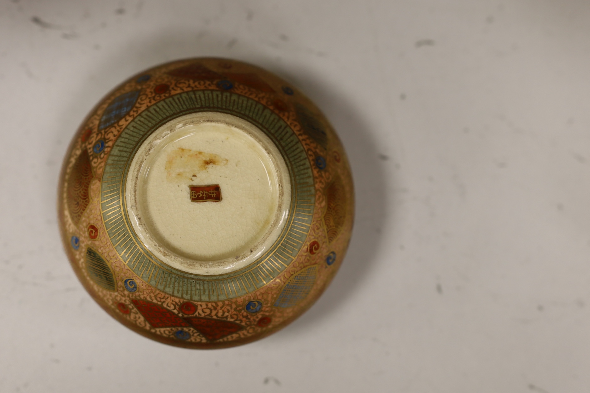 A late 19th century Japanese Satsuma ‘hundred antiques’ gosu blue pot pourri vase and three later items of Satsuma, including a bowl and cover a bowl on stand, a box and cover, tallest 18.5cm high. Condition - vase cover